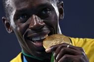 Usain Bolt biting his gold medal won at the 100m sprints at 2016 Rio Games